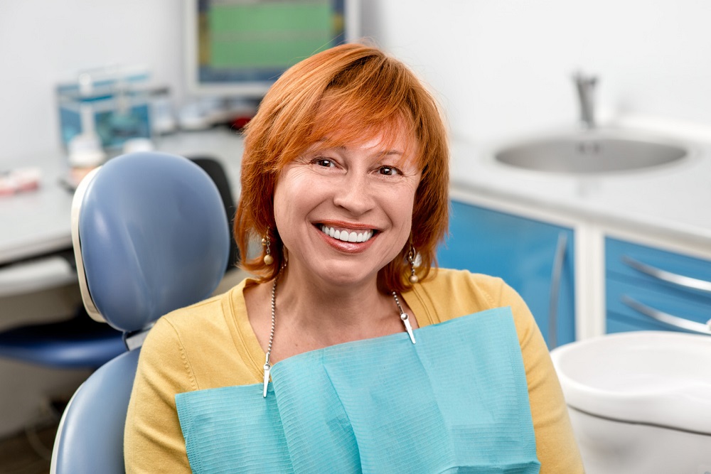 woman is happy after having dentures