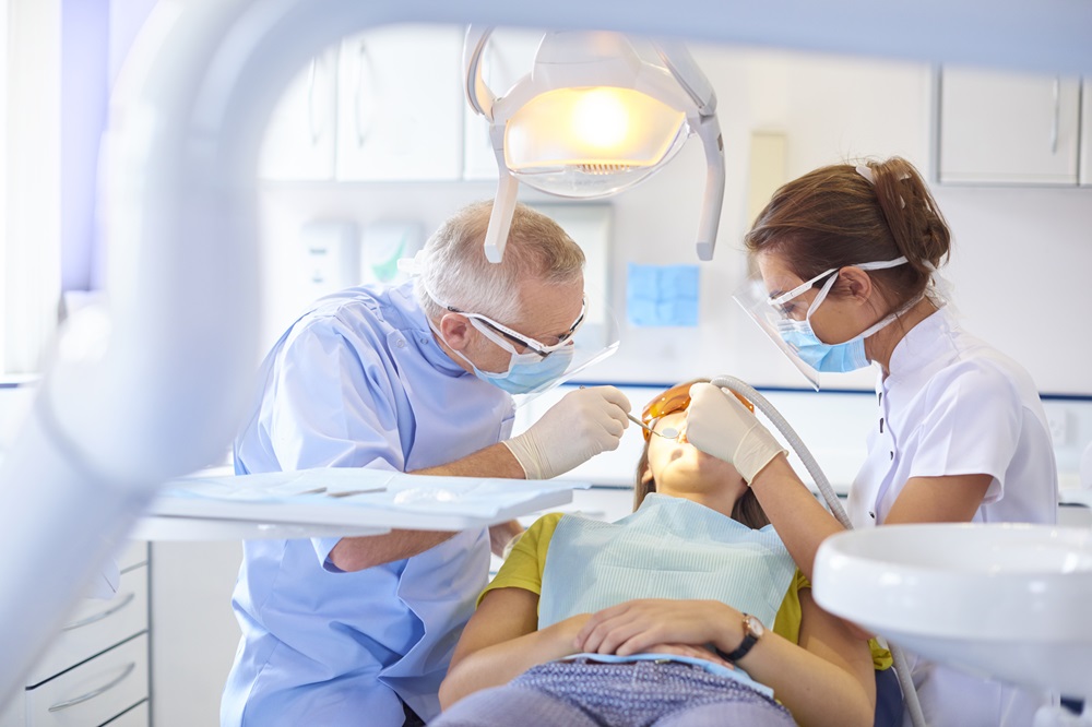 woman taking endodontics treatment at Saskatoon Smiles Dental Studio